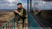 ZAKARPATTIA REGION, UKRAINE - APRIL 7, 2021 - Serviceman Andrii Barabytskyi of the Kosyno border guard unit surveys the terrain from a watchtower at the Ukraine-Hungary state border, Berehove district, Zakarpattia Region, western Ukraine., Credit:Serhii Hudak / Avalon