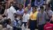 Three people standing in the stands of the US Open wearing shirts that say End fossil fuels Three people standing in the stands of the US Open wearing shirts that say End fossil fuels