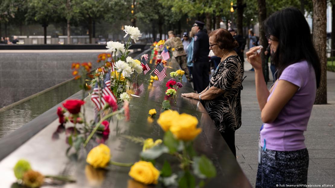 People lay flowers at a 9/11 Memorial in New York.