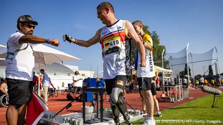 Germany's Armin Witczak and two other men dressed in athletic gear
