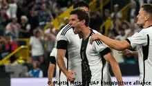 Germany's Thomas Muller celebrates with teammates after scoring the opening goal during the international friendly soccer match between Germany and France in Dortmund, Germany, Tuesday, Sept. 12, 2023. (AP Photo/Martin Meissner)