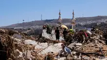 13.09.2023****People walk amidst the debris, following a powerful storm and heavy rainfall hitting the country, in Derna, Libya September 13, 2023. REUTERS/Esam Omran Al-Fetori