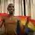 A Rwandan model holds a rainbow flag
