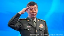 Chinese Defense Minister Li Shangfu salutes before delivering his speech on the last day of the 20th International Institute for Strategic Studies (IISS) Shangri-La Dialogue, Asia's annual defense and security forum, in Singapore, Sunday, June 4, 2023. (AP Photo/Vincent Thian)