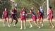 Spanish players stand in a circle looking at a ball as they practise Spanish players stand in a circle looking at a ball as they practise