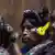Picture of inidgenous women with headphones on at a court trial. 