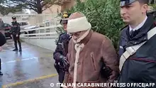 (FILES) This handout video grab taken and released by the Italian Carabinieri Press Office on January 16, 2023 shows the transfer of Italy's top wanted mafia boss, Matteo Messina Denaro (C) from the Carabinieri police station of San Lorenzo in Palermo, to an undisclosed location, following his arrest in his native Sicily on January 16, 2023 after 30 years on the run. Notorious Sicilian Mafia boss Matteo Messina Denaro, captured in January after three decades on the run, is in a coma in hospital and no longer being fed, reports said on September 23, 2023. The 61-year-old has been suffering from colon cancer for several years, and it was his decision to seek treatment that led to his arrest following a visit to a clinic in the Sicilian capital Palermo. (Photo by Handout / ITALIAN CARABINIERI PRESS OFFICE / AFP) / RESTRICTED TO EDITORIAL USE - MANDATORY CREDIT AFP PHOTO / HANDOUT / ITALIAN CARABINIERI PRESS OFFICE - NO MARKETING NO ADVERTISING CAMPAIGNS - DISTRIBUTED AS A SERVICE TO CLIENTS