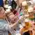 People toasting each other at Oktoberfest with 1 liter glasses of beer