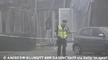 A policeman is seen in front of a damaged building after a powerful explosion occurred in the early morning of September 28, 2023 in a housing area in Storvreta outside Uppsala, Sweden. A 25-year-old woman died in the blast. (Photo by Anders WIKLUND / TT NEWS AGENCY / AFP) / Sweden OUT (Photo by ANDERS WIKLUND/TT NEWS AGENCY/AFP via Getty Images)