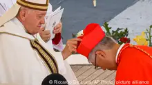 Newly elected Cardinal Stephen Chow, Bishop of Hong Kong, right, receives his biretta from Pope Francis as he is elevated in St. Peter's Square at The Vatican, Saturday, Sept. 30, 2023. (AP Photo/Riccardo De Luca)