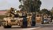 An Israeli self-propelled howitzer and other armored vehicles drive on a highway near the southern city of Sderot An Israeli self-propelled howitzer and other armored vehicles drive on a highway near the southern city of Sderot