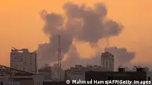 Smoke rises above buildings during an Israeli air strike, in Gaza City on October 9, 2023. Israeli troops fought to regain control of the desert around the Gaza Strip and evacuate people from the embattled border area on October 9, 2023, as the death toll from the war with Hamas surged above 1,100 by the third day of clashes. (Photo by MAHMUD HAMS / AFP) (Photo by MAHMUD HAMS/AFP via Getty Images)