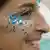 Profile of a woman with glitter on her cheek and under her eye