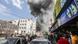 Pessoas em rua de Gaza observam enorme nuvem de fumaça após bombardeio israelense Pessoas em rua de Gaza observam enorme nuvem de fumaça após bombardeio israelense