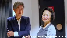 In this photo provided by the Department of Foreign Affairs and Trade, Chinese Australian journalist Cheng Lei, right, poses with Australia's Minister for Foreign Affairs, Penny Wong, at Tullamarine Airport in Melbourne, on Wednesday Oct. 11, 2023. Cheng, who was convicted on murky espionage charges and detained in China for three years has returned to Australia. (Sarah Hodges/DFAT via AP)