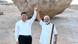 Xi Jinping and Narendra Modi hold hands in front of a rock Xi Jinping and Narendra Modi hold hands in front of a rock