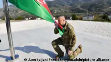 KHOJALY, AZERBAIJAN - OCTOBER 15: (----EDITORIAL USE ONLY - MANDATORY CREDIT - 'AZERBAIJANI PRESIDENCY / HANDOUT' - NO MARKETING NO ADVERTISING CAMPAIGNS - DISTRIBUTED AS A SERVICE TO CLIENTS----) Azerbaijani President Ilham Aliyev hoists the Azerbaijani flag in Khojaly, Azerbaijan on October 15, 2023. Azerbaijani Presidency/Handout / Anadolu