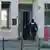 Police enter the Kahal Adass Jisroel Community Center in Berlin after a Molotov cocktail attack