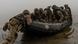 A group of Ukrainian marines sits in a boat on the Dnipro river on the front line A group of Ukrainian marines sits in a boat on the Dnipro river on the front line