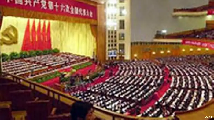 Chinese Communist Party members attend the opening session of the 16th Party Congress, Friday, Nov. 8, 2002 at the Great Hall of the People in Beijing, China. The congress, held once every five years, is expected to bring a new generation of leaders to the world's most populous nation. Banner on top reads Chinese Communist Party 16th National Representative Congress. (AP Photo/Eugene Hoshiko)
