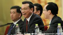 17/03/2013**epa03628343 Newly-elected Chinese Premier Li Keqiang (2-R) reacts as he speaks to reporters while vice-premiers Wang Yang (L), Zhang Gaoli (2-L) and an unidentified interpreter looks on at a press conference after the closing of the 12th National People's Congress (NPC) in the Great Hall of the People in Beijing, China, 17 March 2013. EPA/HOW HWEE YOUNG ++