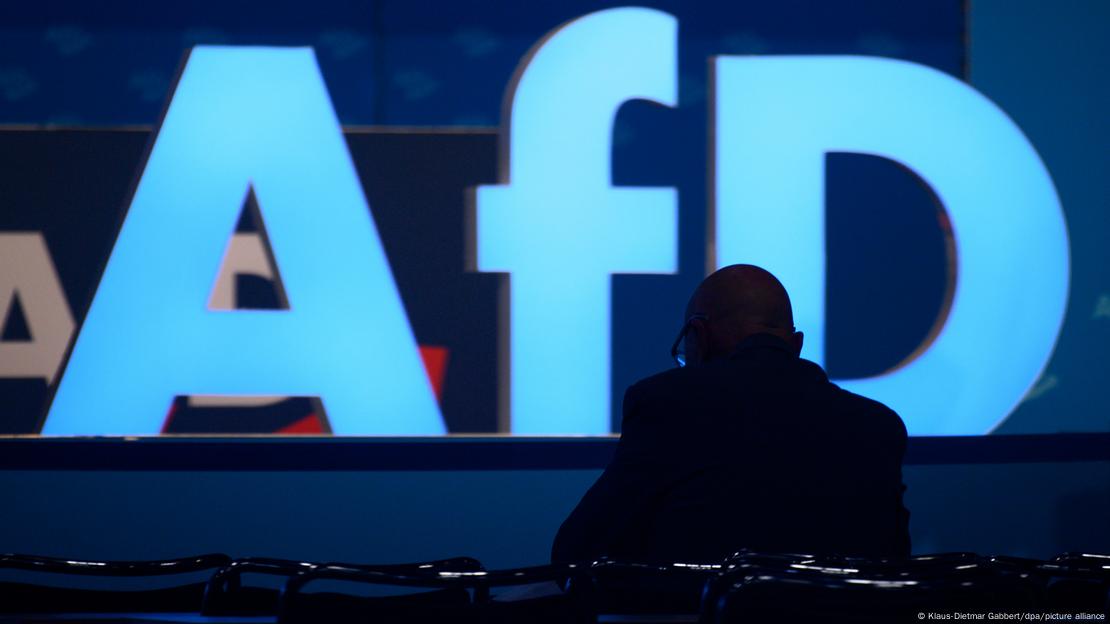 The logo of the Alternative for Germany political party with the silhouette of a person in the foreground