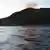 The sun rises as a flotilla of ships (not pictured) approaches a group of islands (C) known as Senkaku in Japanese and Diaoyu in Chinese, early on August 19, 2012.