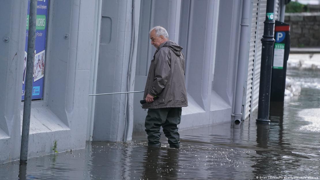 A man pictured wading through water in a south coast community in England