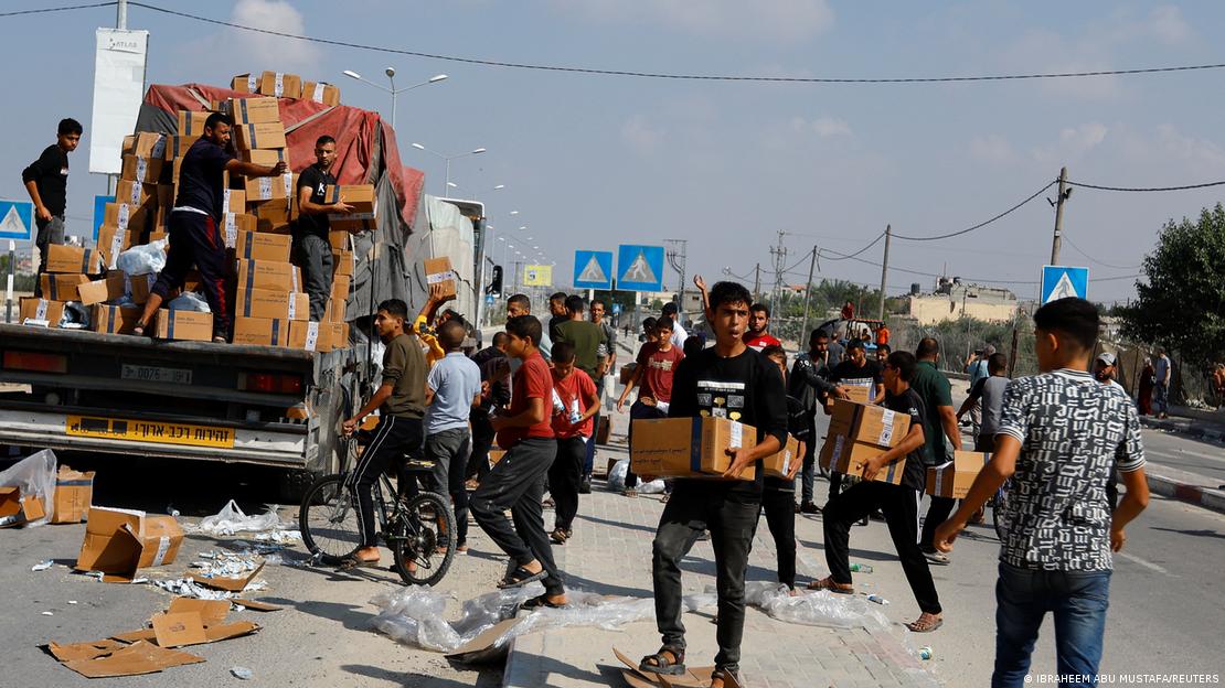 Na Faixa de Gaza, pessoas se aglomeram em busca de mantimentos que são distribuídos a partir de um caminhão.