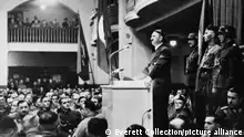 Adolf Hitler giving his annual speech to his old guard at the Munich beer hall, Nov. 8, 1939. Minutes after Hitler left, a bomb planted in the lectern exploded. Nov. 8 was the anniversary of the 1923 Beer Hall Putsch in the Burgerbraukeller, Munich. World War 2. (BSLOC_2014_8_168)