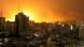 Explosions can be seen in the distance in Gaza city Explosions can be seen in the distance in Gaza city