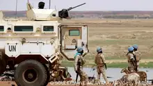Senegalese soldierS the UN peacekeeping mission in Mali MINUSMA (United Nations Multidimensional Integrated Stabilisation Mission in Mali) dismount an armoured personnel carrier, patrolling in the streets of Gao, on July 24, 2019, a day after suicide bombers in a vehicle painted with UN markings injured one French, several Estonian troops and two Malian civilians in an attack on an international peace-keeping base in Mali. - Malian authorities have struggled to improve security since France intervened in 2013 to drive back Islamic insurgents in the north. Around 4,000 French troops are deployed under Operation Barkhane alongside the MINUSMA peacekeeping force of around 15,000 soldiers and police. (Photo by Souleymane Ag Anara / AFP) (Photo credit should read SOULEYMANE AG ANARA/AFP via Getty Images)