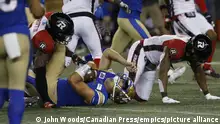 THE CANADIAN PRESS 2022-06-10. Winnipeg Blue Bombers quarterback Zach Collaros (8) gets hit by Ottawa Redblacks' Randall Evans (2) and is taken off as per concussion protocol during the second half of CFL action in Winnipeg, Friday, June 10, 2022. THE CANADIAN PRESS/John Woods URN:67375891