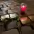candle burns near rose on "stolpersteine," monuments to people killed by Nazi Germany