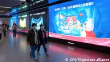 (FILE) Citizens pass posters of Tmall Taobao Double 11 shopping carnival on a subway in Shanghai, China, October 29, 2022.
