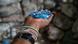 A detail of a man's hands holding a pile of shredded blue plastic A detail of a man's hands holding a pile of shredded blue plastic