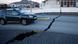 A car drives toward a fissure in a road in the town of Grindavik, Iceland A car drives toward a fissure in a road in the town of Grindavik, Iceland