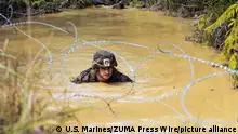 24.03.2022
March 24, 2022 - Camp Gonsalves, Okinawa, Japan - U.S. Marine Corps Capt. Christopher Smaldone, training officer of Headquarters Company, III Marine Expeditionary Force Information Group (III MIG) swims through a water obstacle during an endurance course at Jungle Warfare Training Center (JWTC), Camp Gonsalves, Okinawa, Japan, March 24, 2022. The endurance course is the culminating event of Basic Jungle Skills Course (BJSC), it consists of traveling through 3.8 miles of jungle terrain, overcoming multiple physical obstacles, water obstacles and rappelling cliffs and hills. Marines with III MIG traveled to JWTC to participate in the BJSC, which consists of jungle medicine, communication, rappelling, land navigation and an endurance course, to hone their ability to conduct command and control operations in an austere environment. (Credit Image: © U.S. Marines/ZUMA Press Wire Service/ZUMAPRESS.com