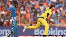 AHMEDABAD, INDIA - NOVEMBER 19: Mitch Marsh of Australia in bowling action as Virat Kohli of India loduring the ICC Men's Cricket World Cup India 2023 Final between India and Australia at Narendra Modi Stadium on November 19, 2023 in Ahmedabad, India. (Photo by Robert Cianflone/Getty Images)