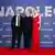 Picture shows three people identified as actor Joaquin Phoenix, director Ridley Scott and actor Vanessa Kirby standing on a red carpet with the word 'Napoleon' printed on the background. 