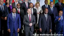 German Chancellor Olaf Scholz, center, stands with heads of state and government of African countries, as well as the heads of the EU for a family photo at the Compact with Africa - G20 Investment Summit 2023 conference, in Berlin, Monday Nov. 20, 2023. (Kay Nietfeld/Pool via AP)