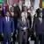 German Chancellor Olaf Scholz (c) smiles as he stands among other leaders lined up at the Compact with Africa summit.