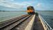 The train bridge of the Rot Fai Loi Nam Train or floating train line at the Pa Sak Jolasid Dam near the City of Lopburi in the Province of Lopburi in Thailand The train bridge of the Rot Fai Loi Nam Train or floating train line at the Pa Sak Jolasid Dam near the City of Lopburi in the Province of Lopburi in Thailand