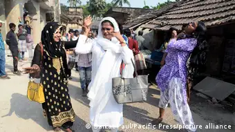 A group of hijras dancing in the street