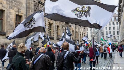 Приврзеници на „Граѓани на Рајхот“ со знамиња на кралството Прусија за време на демонстрации во октомври 2023 година. 