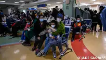 Children and their parents wait at an outpatient area at a children hospital in Beijing on November 23, 2023. The World Health Organization has asked on November 23, 2023, China for more data on a respiratory illness spreading in the north of the country, urging people to take steps to reduce the risk of infection. China has reported an increase in influenza-like illness since mid-October when compared to the same period in the previous three years, the WHO said. (Photo by Jade Gao / AFP)