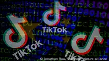 21/03/2023 **The TikTok logo is seen on a mobile with cyber code displayed on the screen in Brussels, Belgium, on March 21, 2023. (Photo Illustration by Jonathan Raa/NurPhoto)