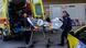 Medical staff carry on a stretcher a survivor from the Comoros-flagged cargo ship that has sunk off the island of Lesbos, on November 26, 2023 Medical staff carry on a stretcher a survivor from the Comoros-flagged cargo ship that has sunk off the island of Lesbos, on November 26, 2023