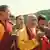 Film still from 'The Monk and the Gun': a group of Bhutanese people gather together, two are in monk dress. 
