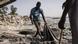 A man pulls material out of the sand during a beach clean up along Hann Bay in Dakar A man pulls material out of the sand during a beach clean up along Hann Bay in Dakar
